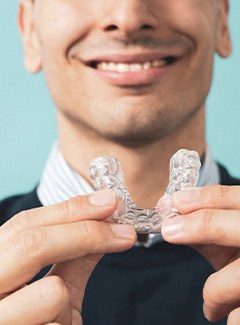 Man holding his custom oral appliance