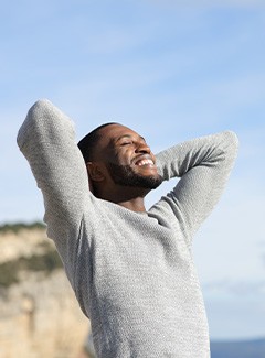 Happy man standing outside during beautiful weather