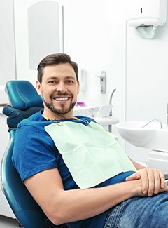 Man in blue shirt sitting in dental chair