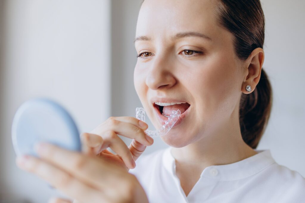 Woman putting on retainer